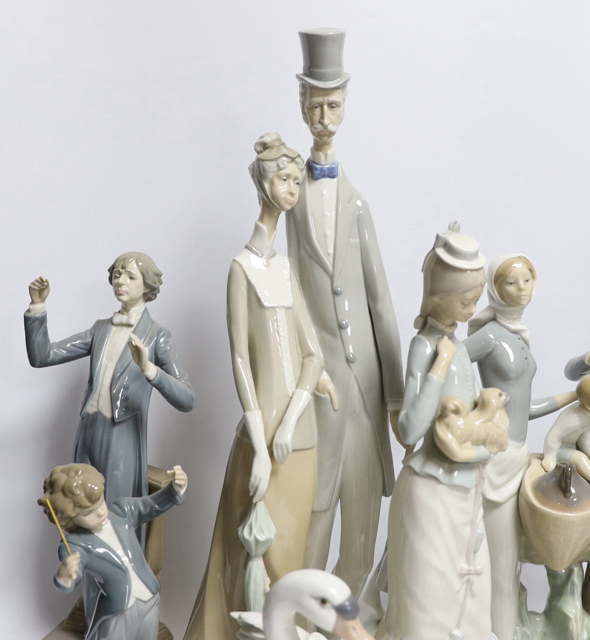 A collection of various Lladro figures including composers, swans, etc. tallest 50cm